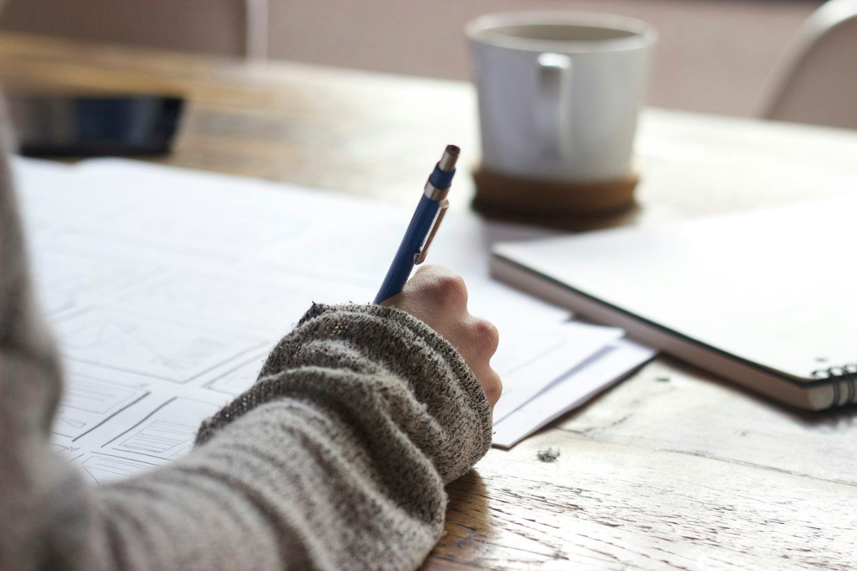 Focused student studying with structured notes and exam preparation materials